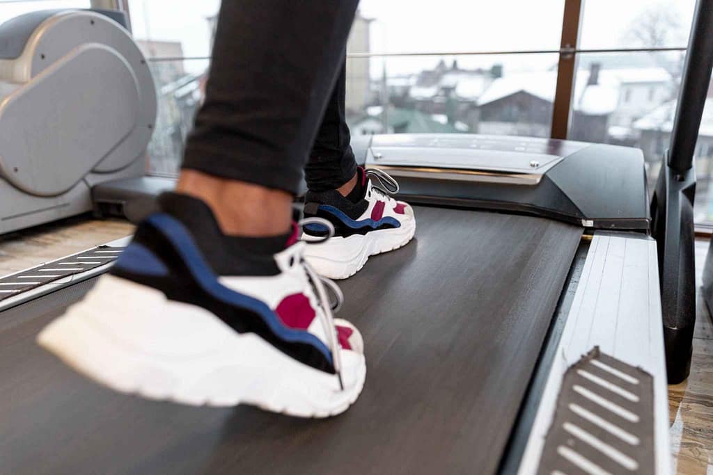 Close-up of colorful sneakers in action during a treadmill workout.