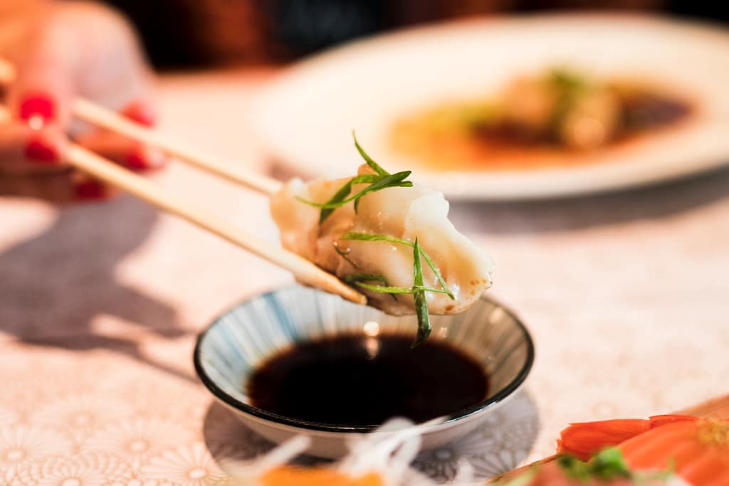 dipping-soy-sauce_11zon Delicious dumpling dipped in teriyaki sauce for a burst of flavor.