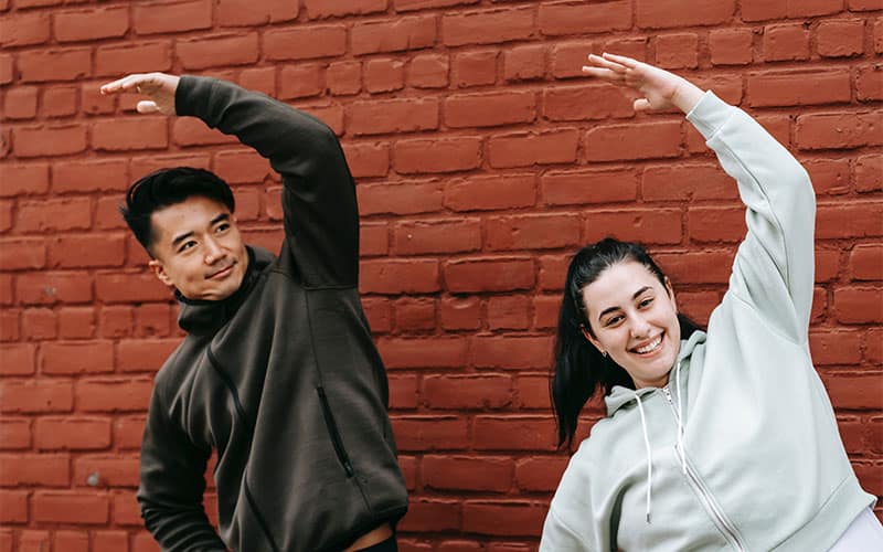 the trainer and trainee are stretching